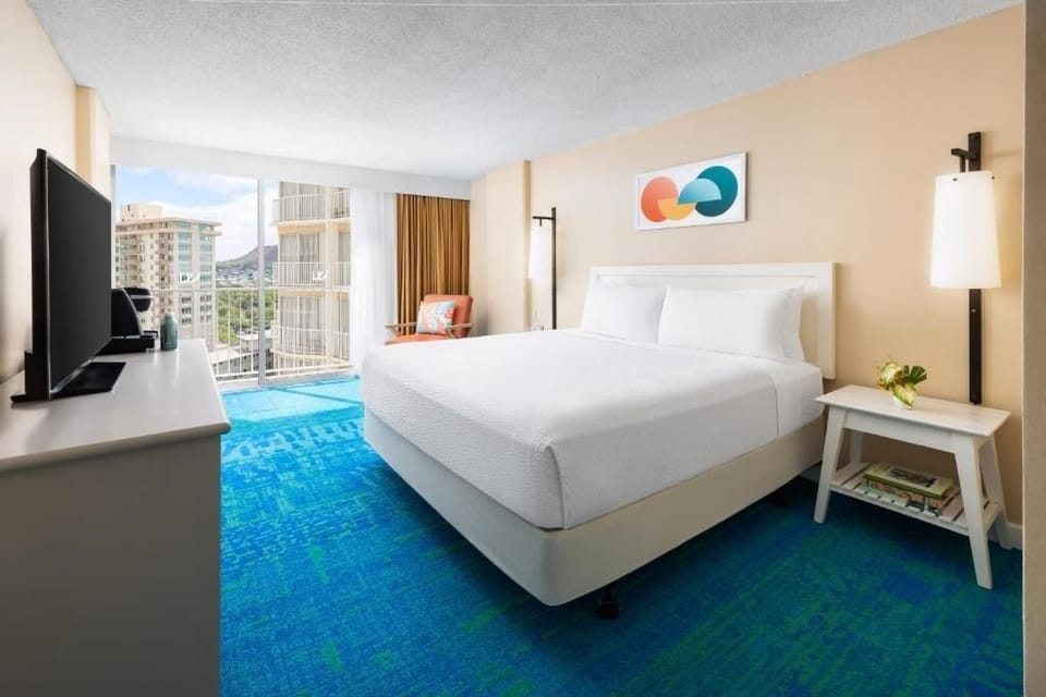 Relax in a spacious room with balcony breezes nearby.