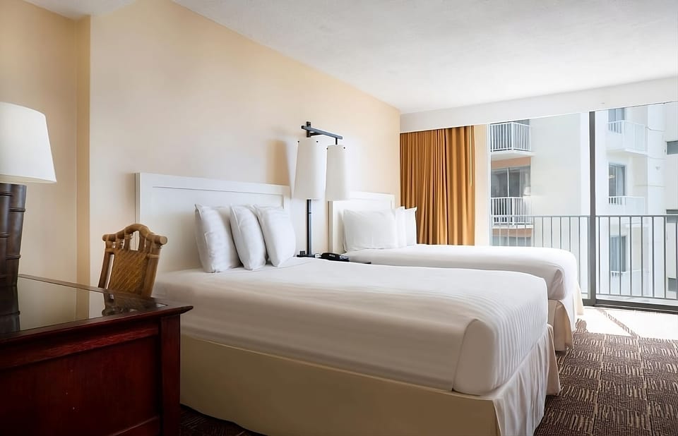 Settle in together with two comfy beds and balcony views.