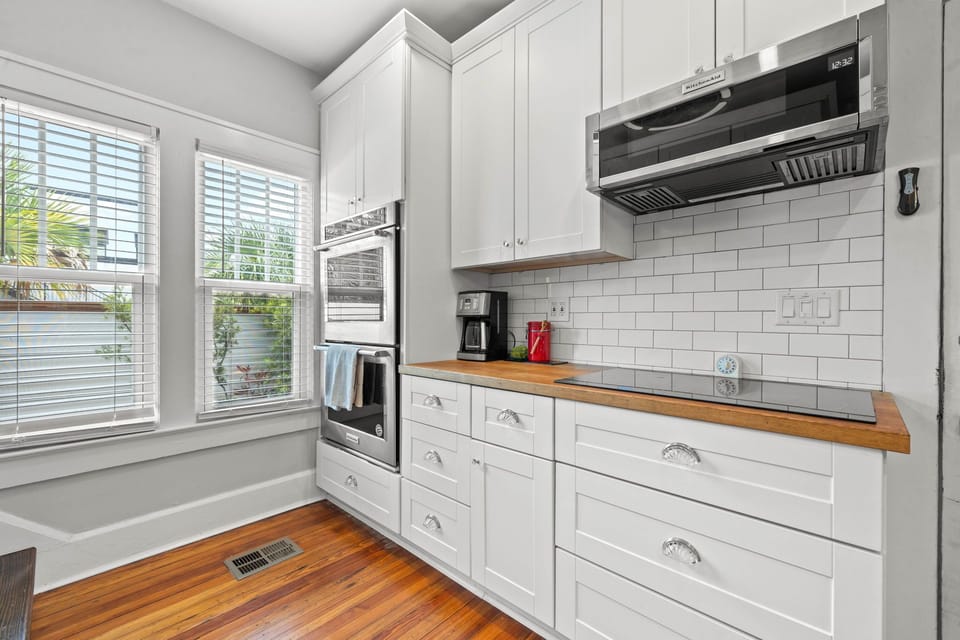 Stovetop counter with coffee and double oven and microwave