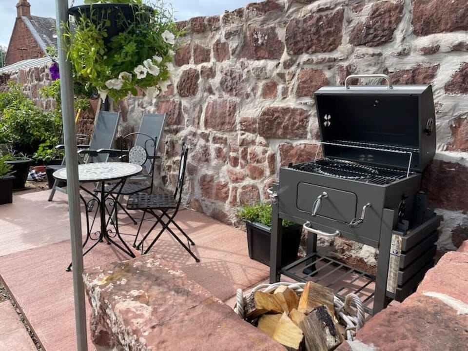 Patio area in garden with BBQ.