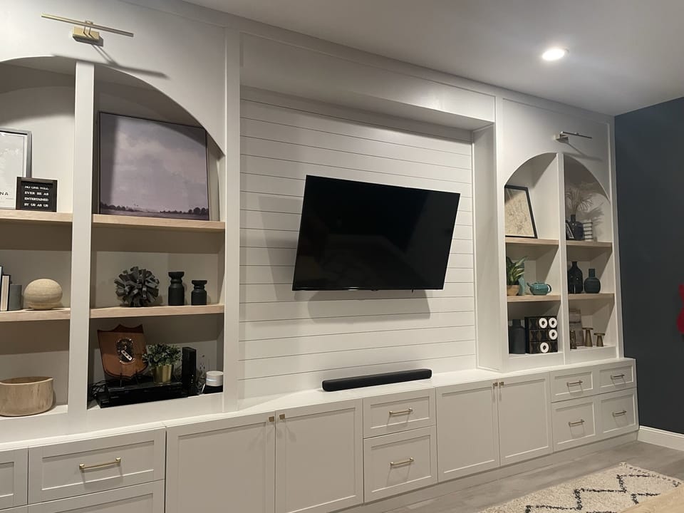 Office space/den with sofa and large TV.  Full desk space not pictured.  