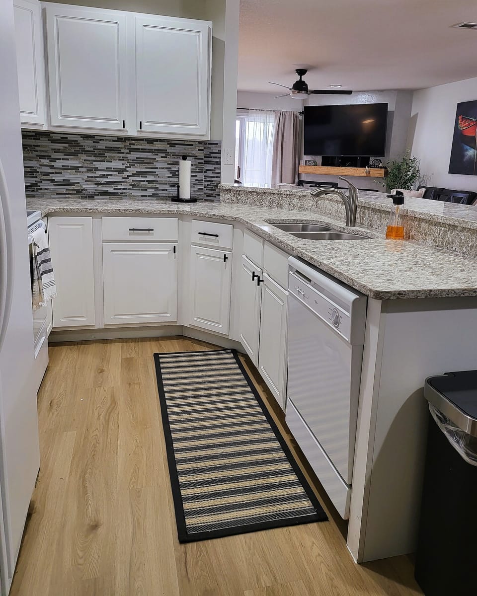 Kitchen with microwave, oven, refrigerator and dishwasher.