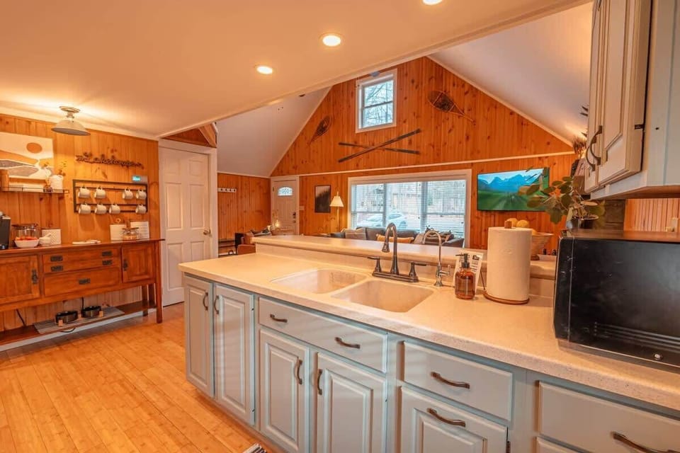Complete with elegant wood paneling and a stylish sink. Whether you're brewing coffee or baking in the oven, this space is designed for your comfort and convenience.