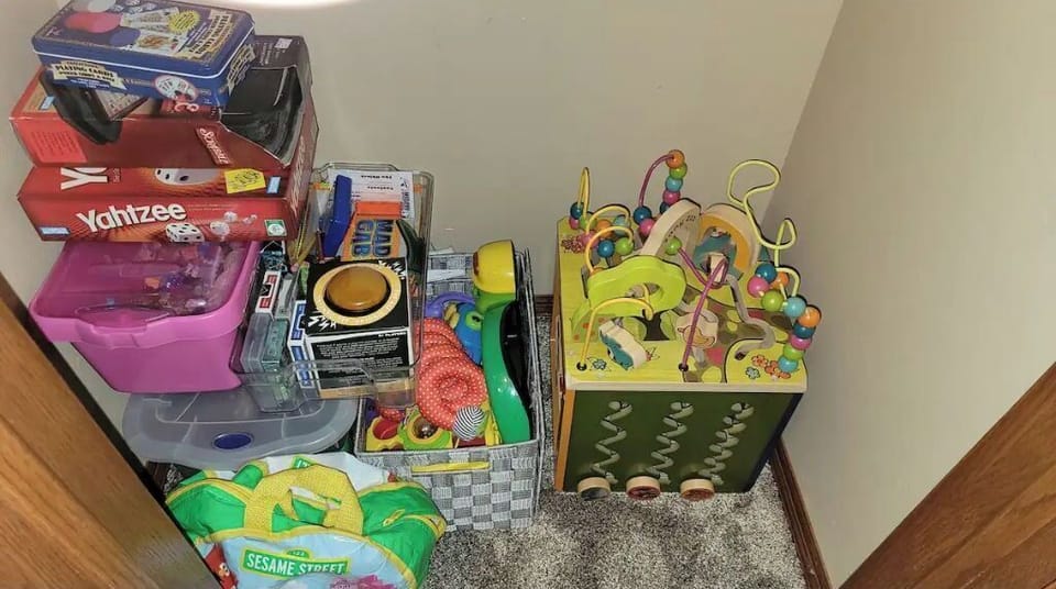 Closet next to half bathroom with games and toys for every age