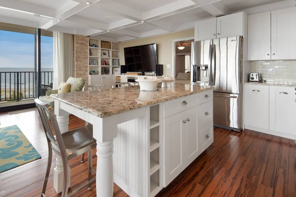 Kitchen island/bar centrally located.