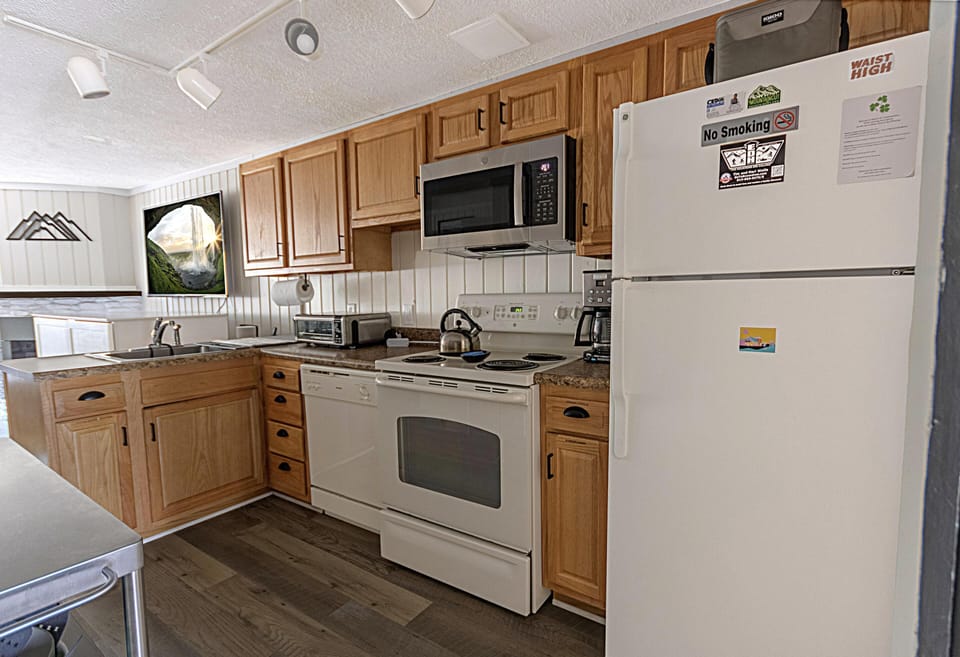 This generous kitchen offers all the essentials for effortless and delicious home-cooked meals.