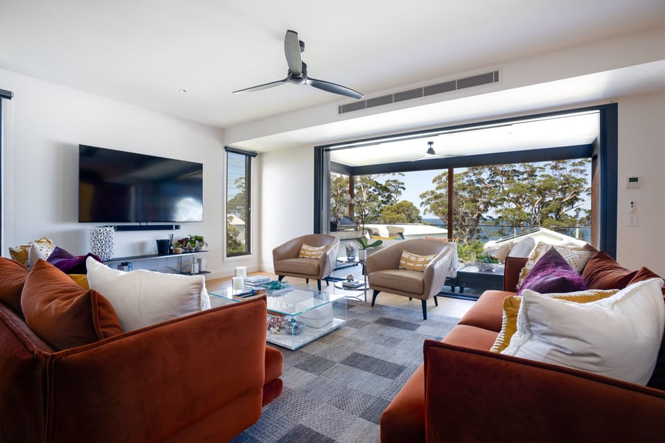 Living space leading out to large outdoor living and overlooking the water
