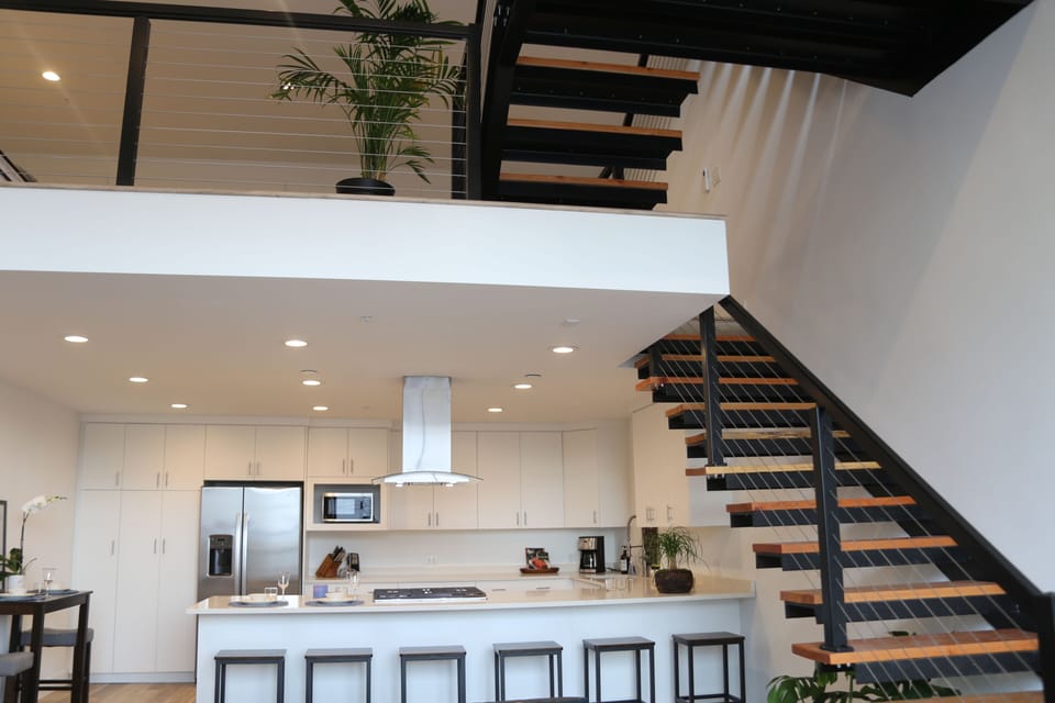 View into our fully equipped kitchen and up the stairs to the mezzanine