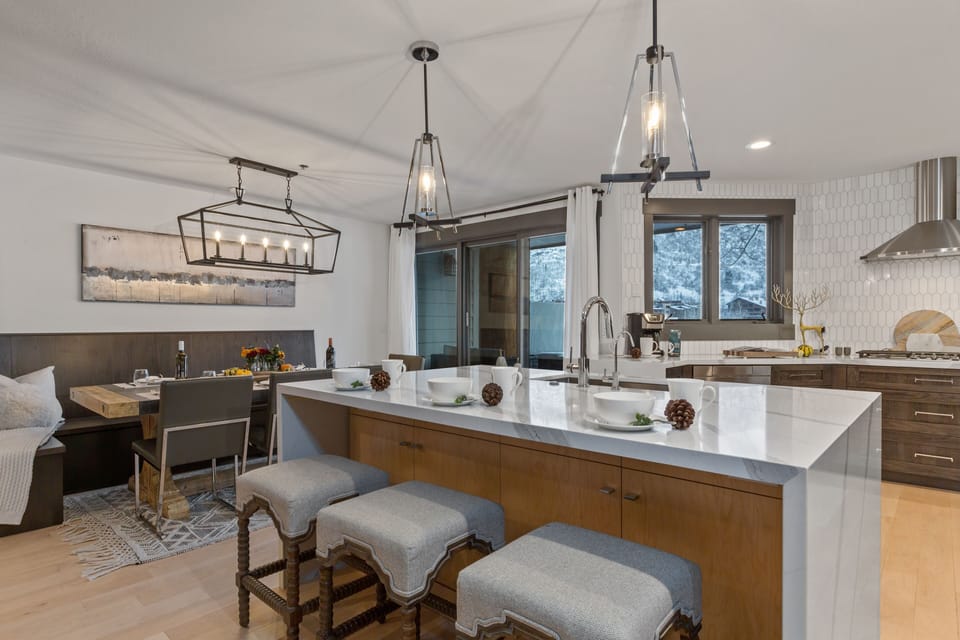 Fully Equipped Kitchen with stainless steel appliances, gorgeous stone countertops, and island seating for three