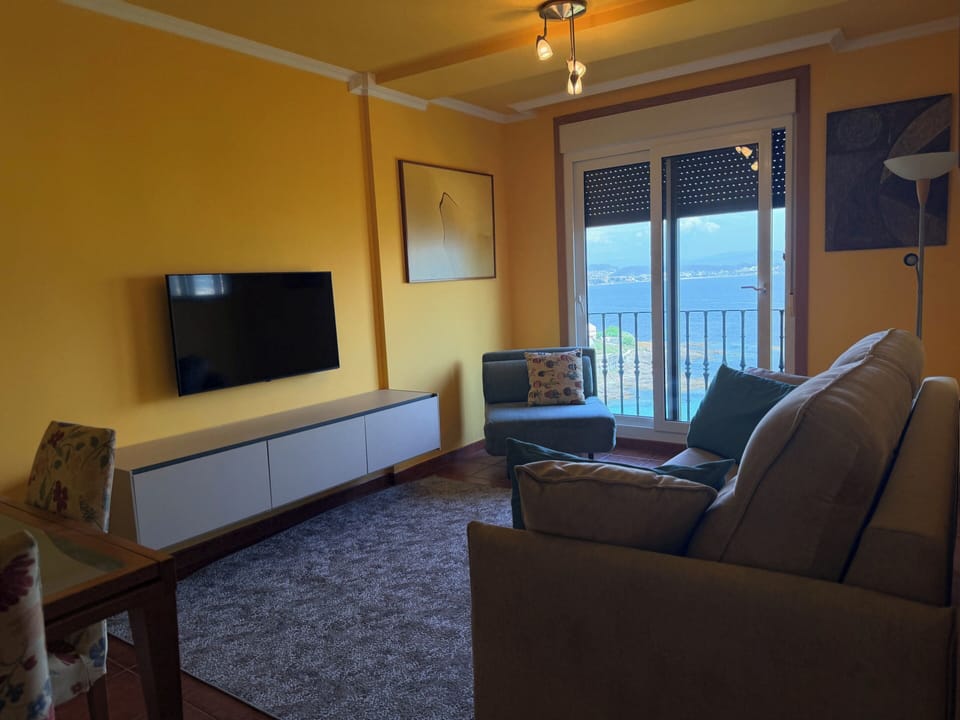 Living room with a 2m sofa bed (closed), a chaise lounge convertible into a child’s bed (closed), TV, and dining table