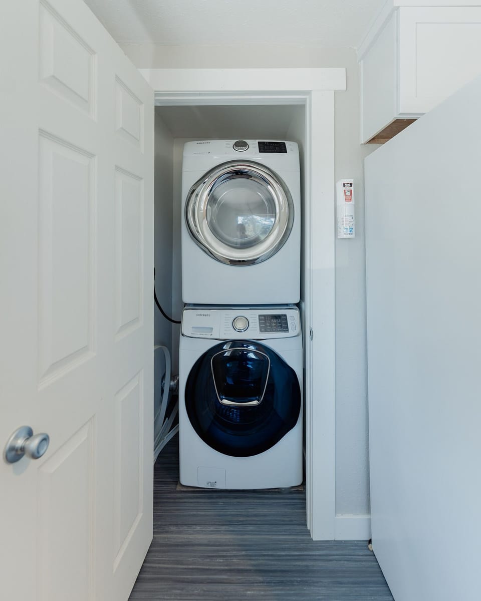Stackable washer and dryer unit for use during stay at end of kitchen. 