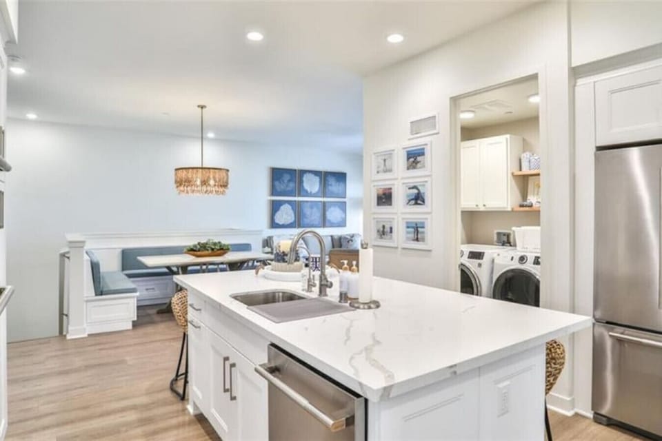 Fully Stocked Gourmet Kitchen with Stainless Appliances and Seating for Five at the Breakfast Bar Plus the Adjacent Laundry Room