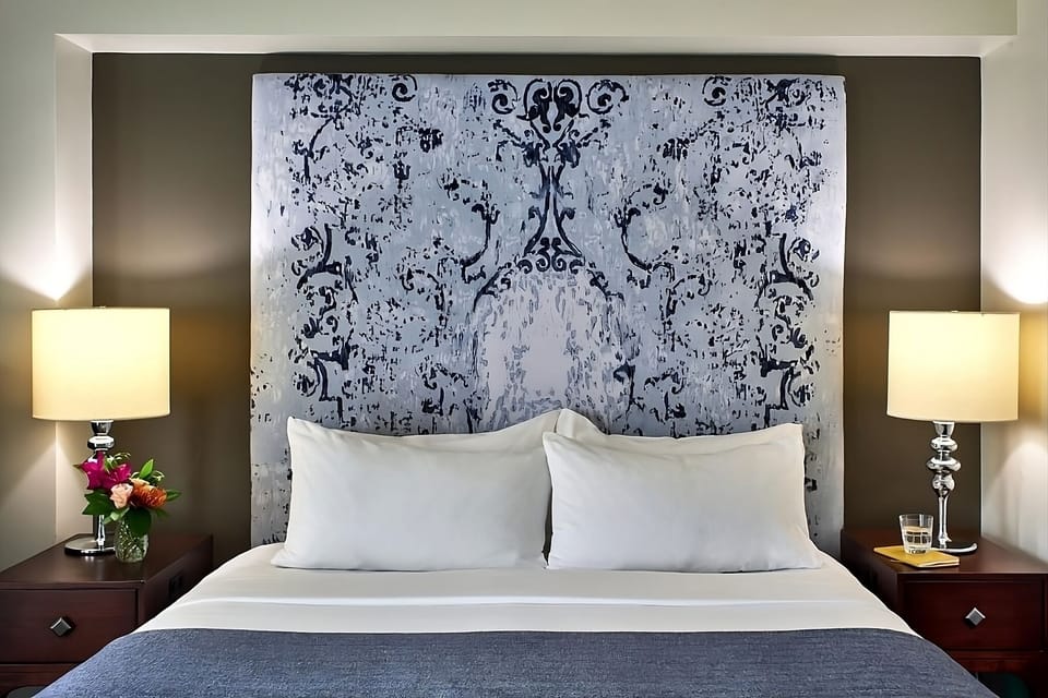 Sink into crisp linens beneath a statement headboard wall.