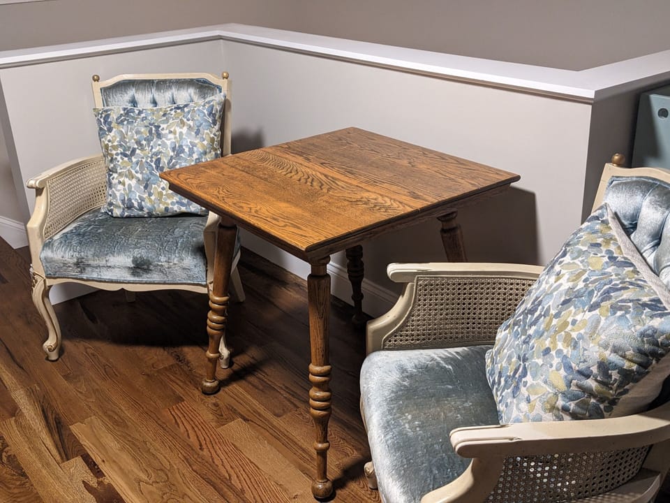 Second floor sitting area with small couch, TV and games. 
