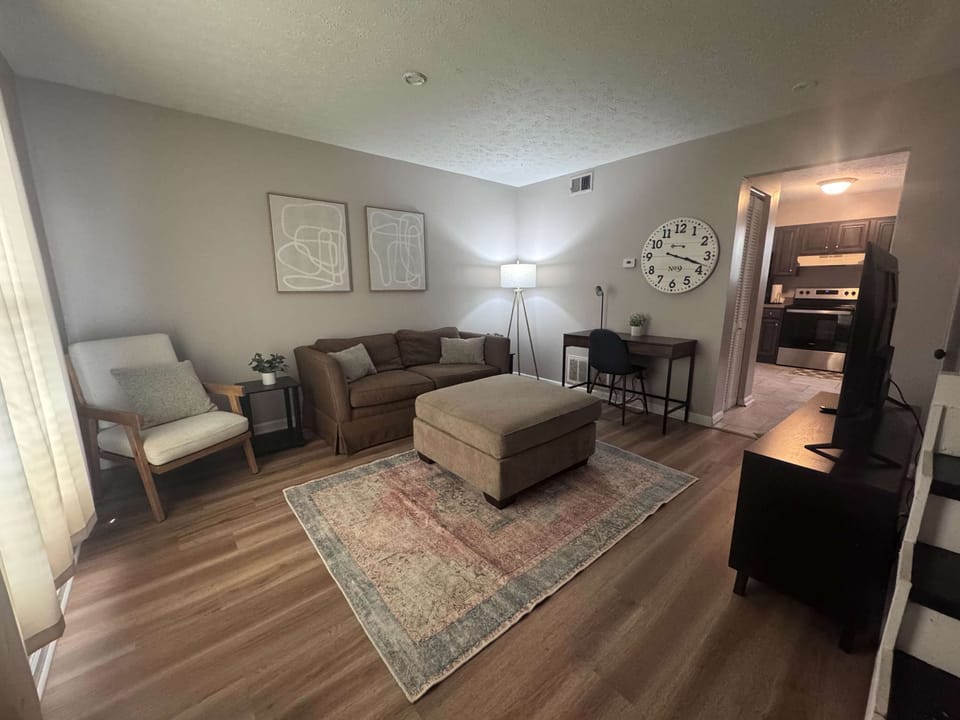 Living Room: Welcome to our roomy living room, furnished with a cozy loveseat, a mini side table, and a coffee table.