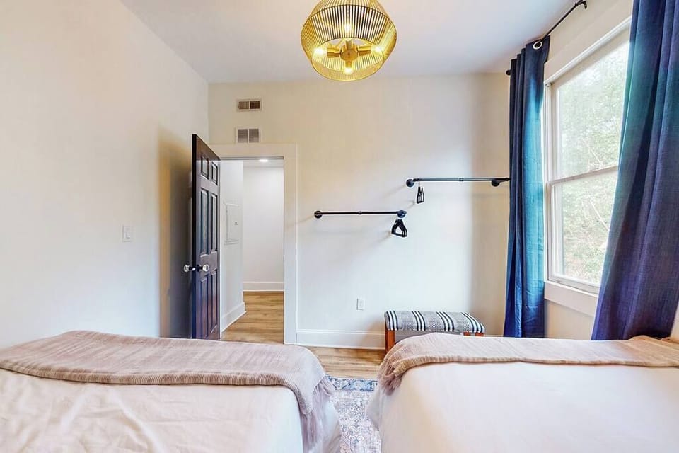 Bedroom 2: Just beside the door, there is a wall hanging rack to keep your clothes organized.