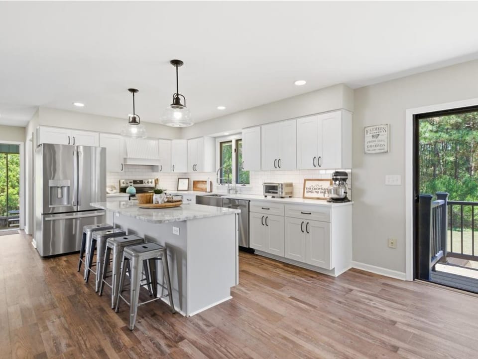 Bright and airy, this fully equipped kitchen invites you to gather, cook, and create memories together. Modern appliances, ample counter space, and a welcoming island make meal prep a breeze.
