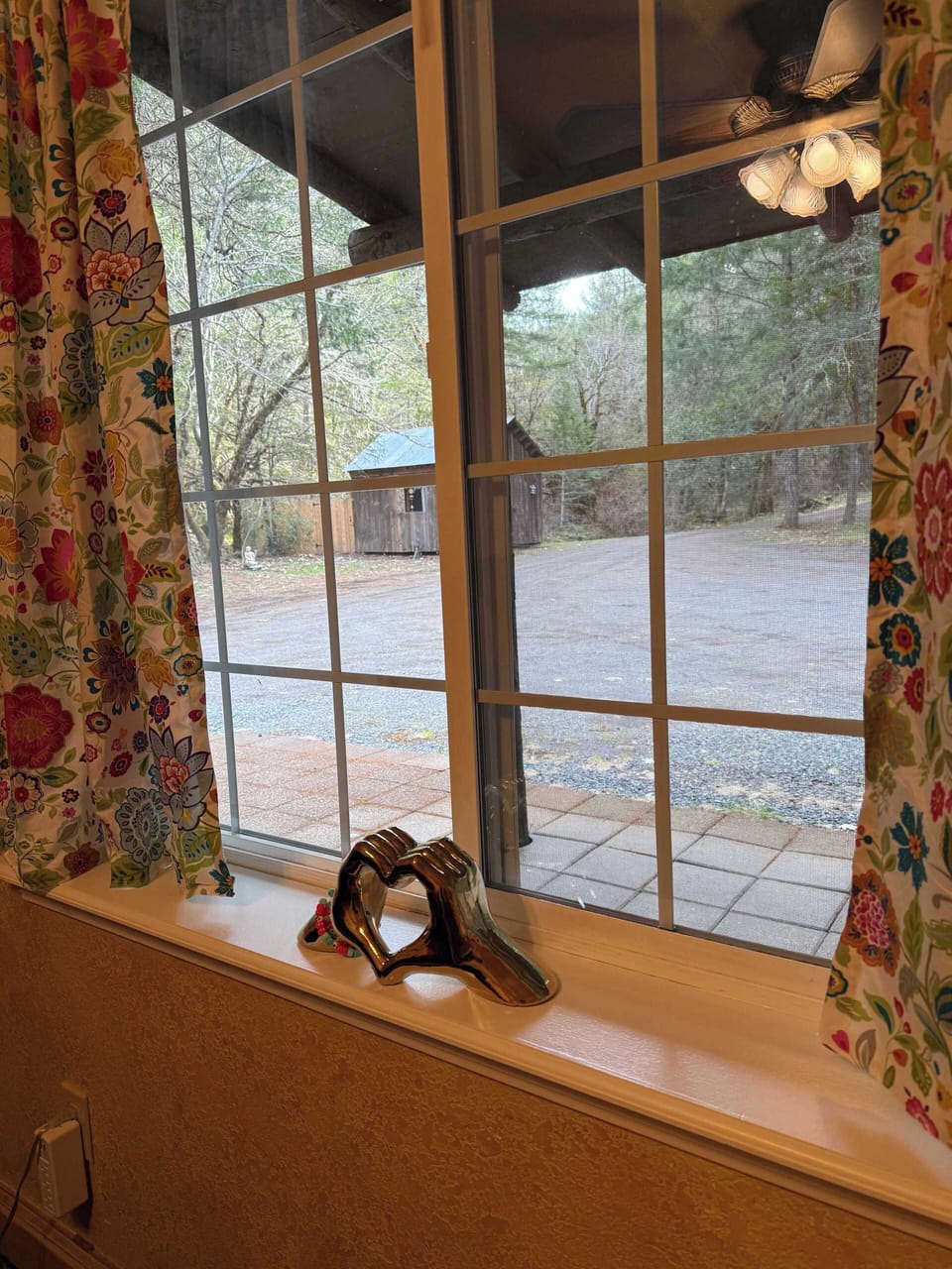 Out the window is the driveway up to the Cedar House. The little building is called The House of Eve. We use it for massage in the summer.