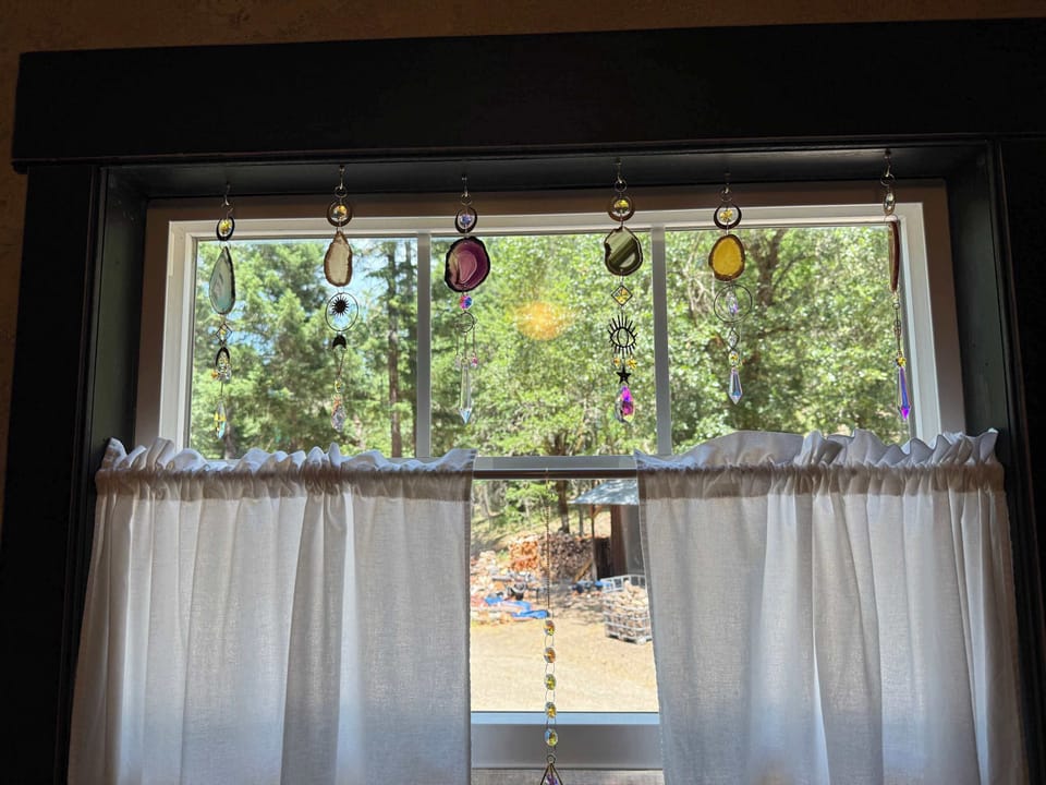 Sun-catcher crystal window décor in the cottage bathroom.
