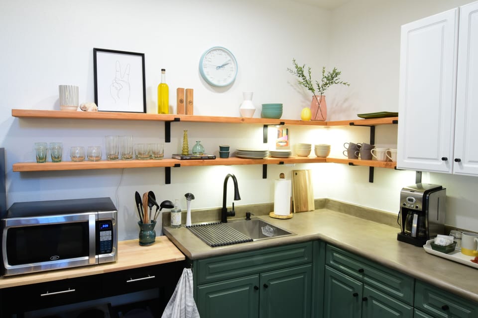 Pots/pans, knives, microwave, two-burner cooktop, coffee pot, water kettle