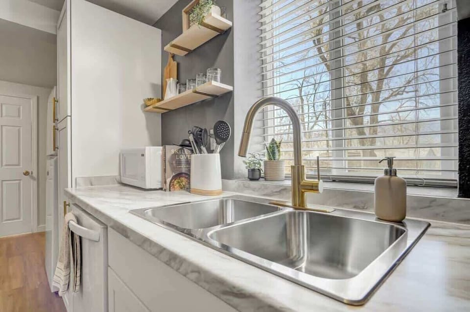 Step into our kitchen, showcasing a sink, dishwasher, microwave, and captivating window views. Your ideal culinary haven awaits
