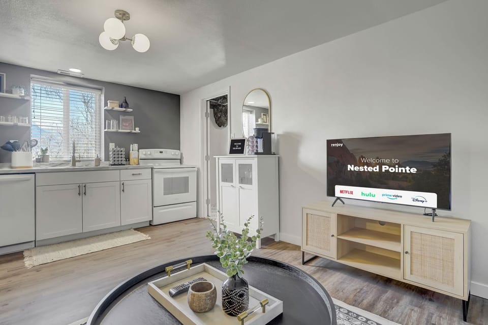 On the left side of the living room, you'll find the kitchen, offering the opportunity to cook and do dishes while relishing the beautiful nature and scenery. Plus, there's a rug for your safety and comfort