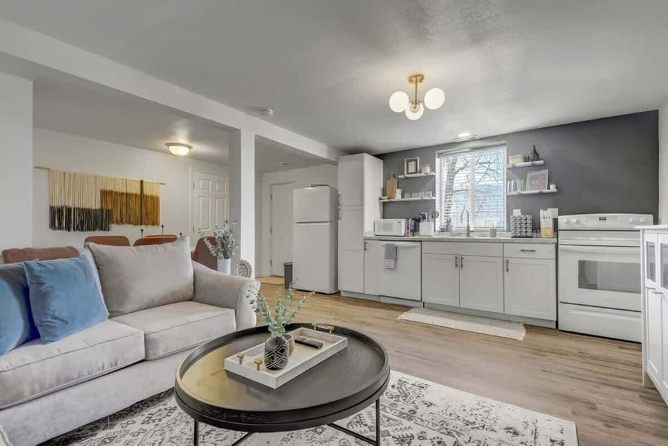 Our living room seamlessly connects to a fully-equipped kitchen and a roomy dining area. The expansive window bathes the space in ample natural light, allowing you to cook while keeping up with your favorite TV shows