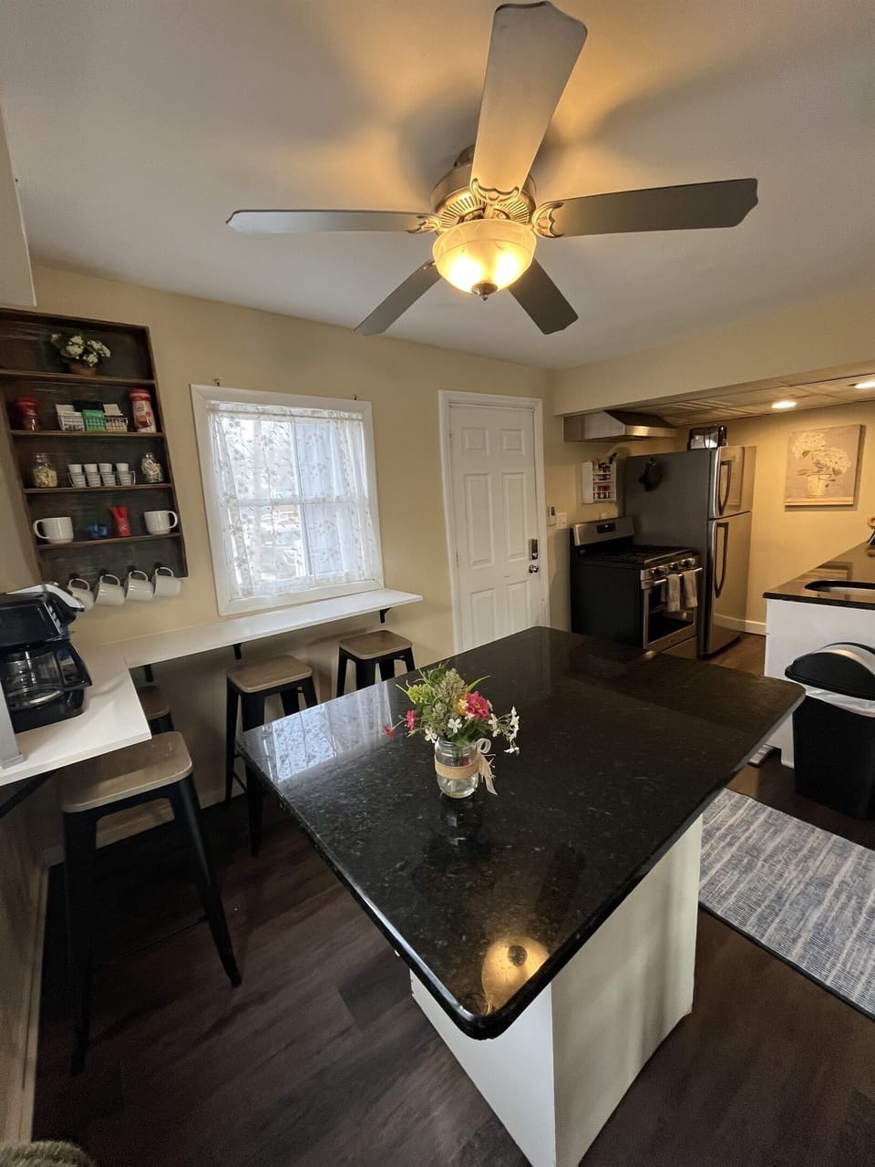 Fully stocked kitchen with a coffee bar and island for extra seating.