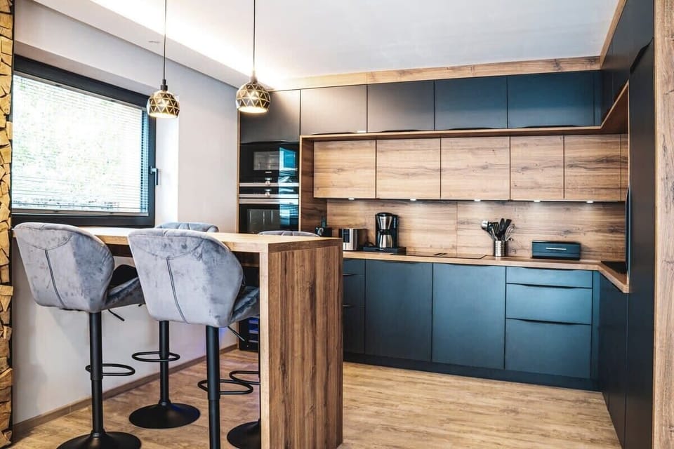 The spacious designer kitchen with Siemens appliances, downdraft induction cooktop, wine cooler, dishwasher, large refrigerator with small freezer compartment, and a large variety of toasters, blenders, Nespresso and other coffee machines.