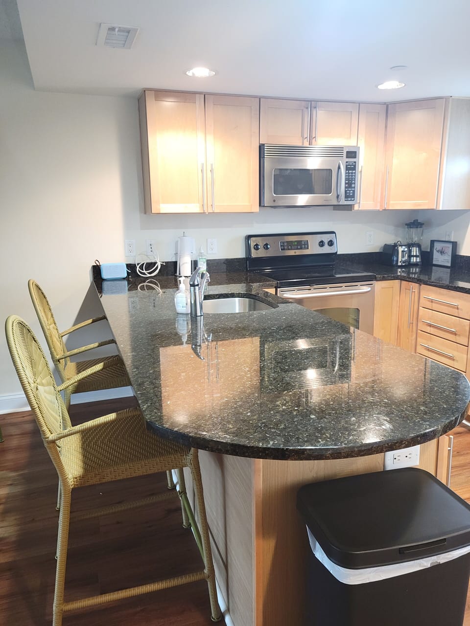 stainless steel appliances and seating for 2 at the kitchen island 