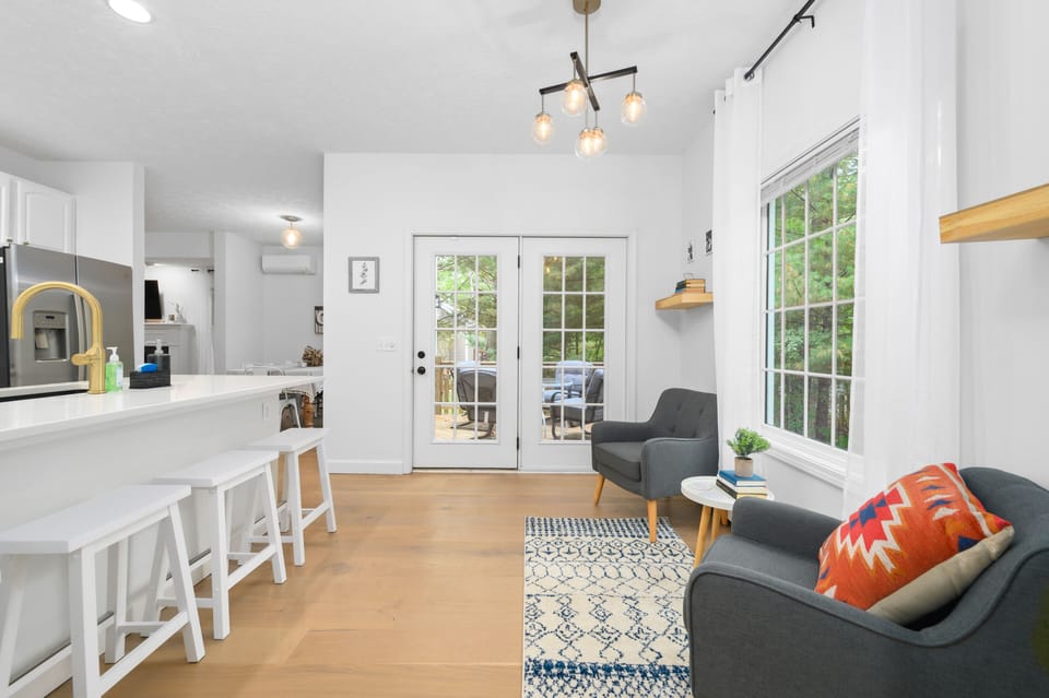 Tucked among tall trees and just a short walk to downtown Traverse City, this stunningly renovated home blends cozy comfort with a prime location.