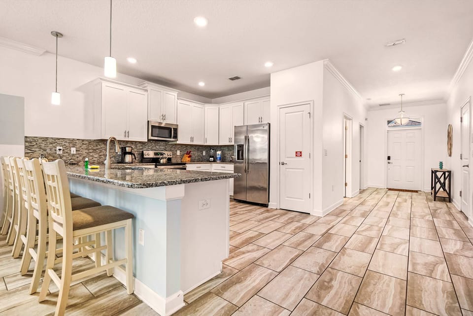 Elegant kitchen with granite countertops and seating for six, perfect for family gatherings and culinary adventures.