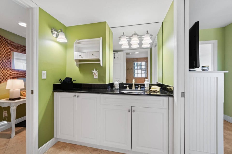 The bathroom vanity offers plenty of surface area and storage space.