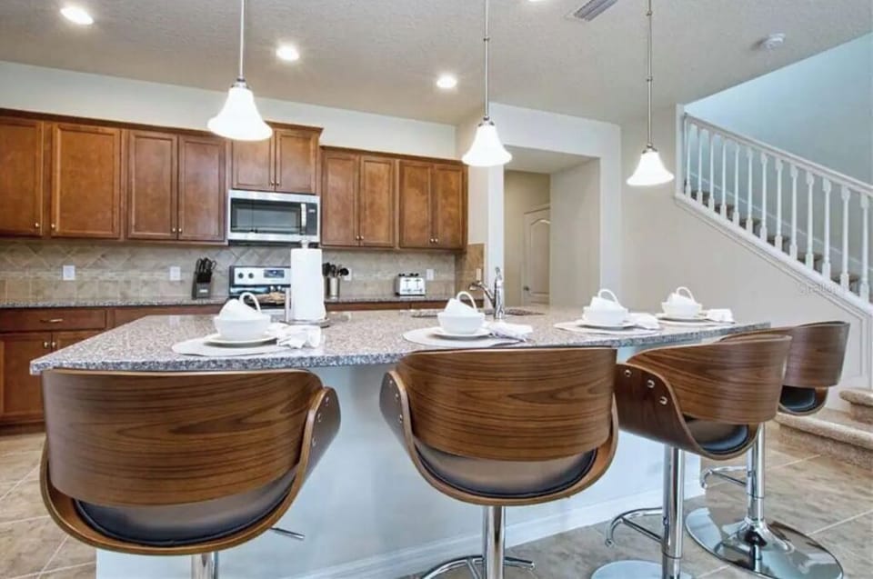 The kitchen is stocked with dinnerware, pots and pans