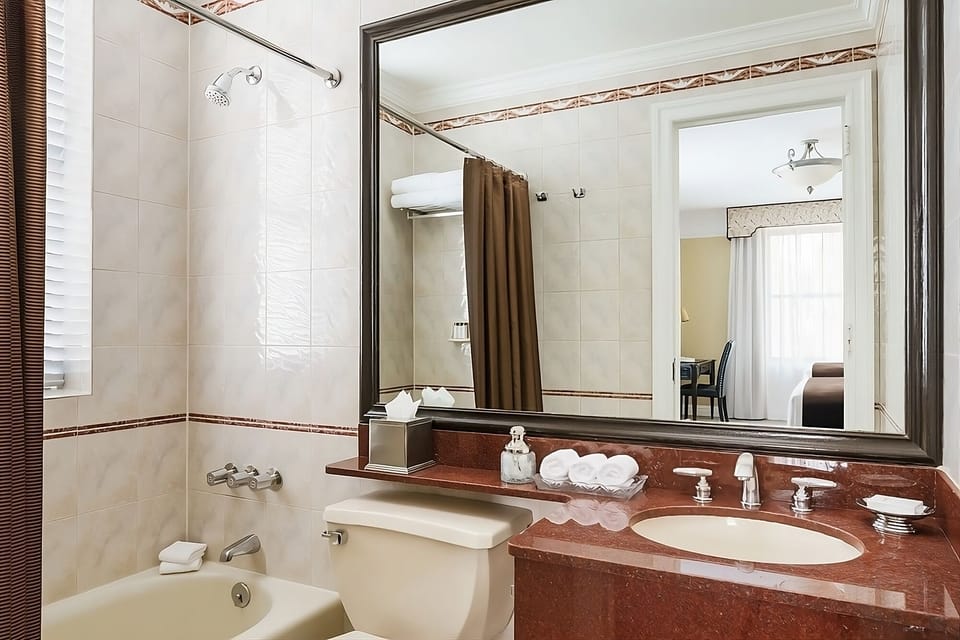 Refresh with a deep tub, bright vanity, and fluffy towels.