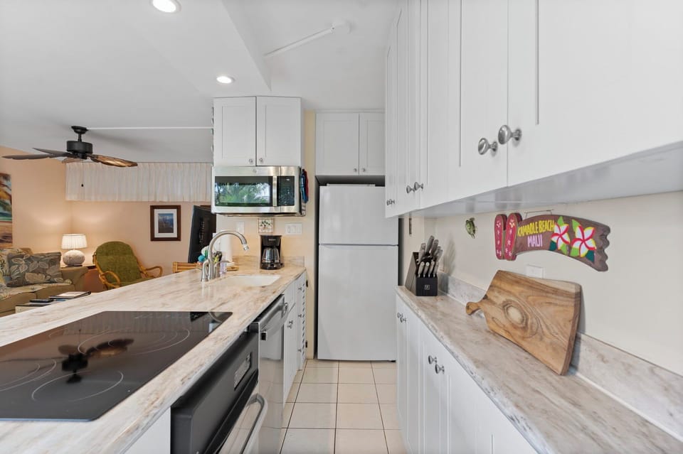 Kitchen cabinets are stocked with cookware~ glassware & more.