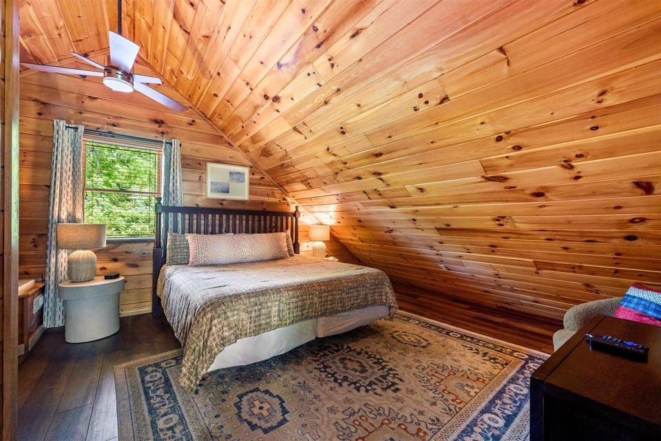 A king suite tucked under the eaves — ensuite bath and Jacuzzi tub of its own.