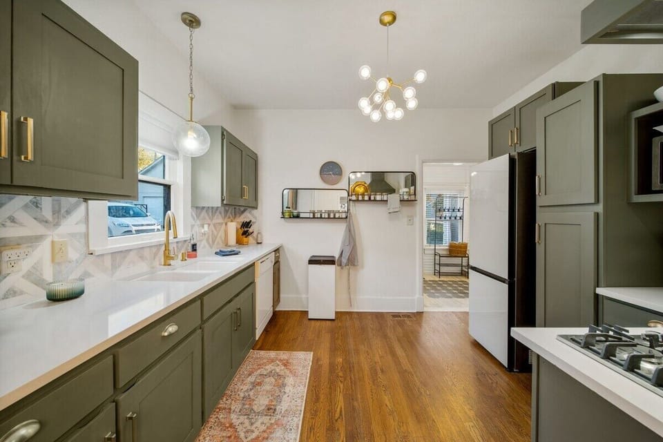 There is a sight line from the back door all the way through the mudroom, kitchen and dining room, into the living room and out the front door allowing for lots of natural light. Original hardwood floors have been refinished.