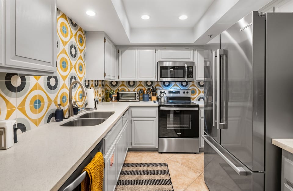 Unique stone tilework, quartz countertops, and new stainless appliances. Fully stocked kitchen!