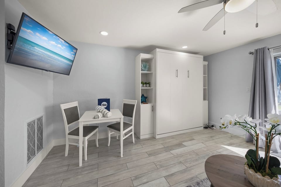 Your modern studio features a Murphy bed, dining nook, and wall-mounted TV for comfortable relaxing after exploring.