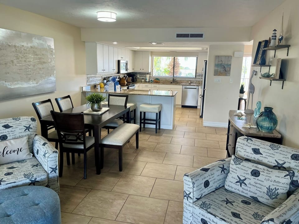 Relax in this bright, coastal-themed space where your fully-equipped kitchen flows seamlessly into comfortable living and dining areas.