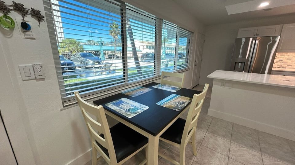 Your bright dining nook offers the perfect spot for morning coffee and planning adventures, with natural light streaming through the blinds.
