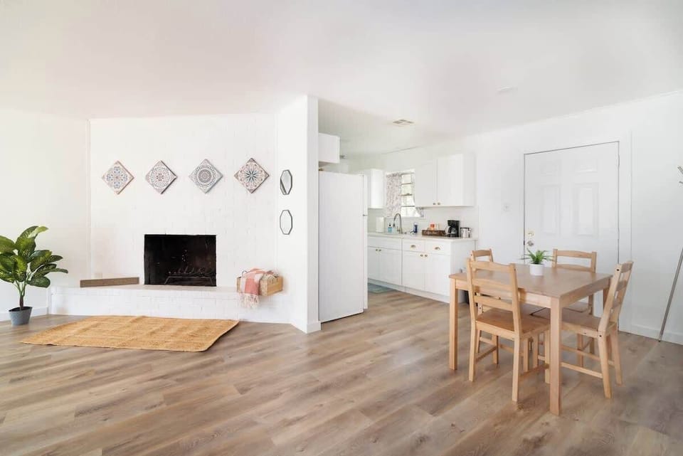 Open-concept dining and living space with fireplace