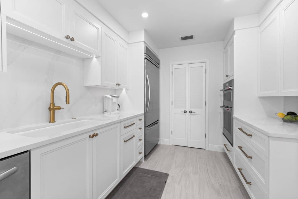 Kitchen leading into large pantry