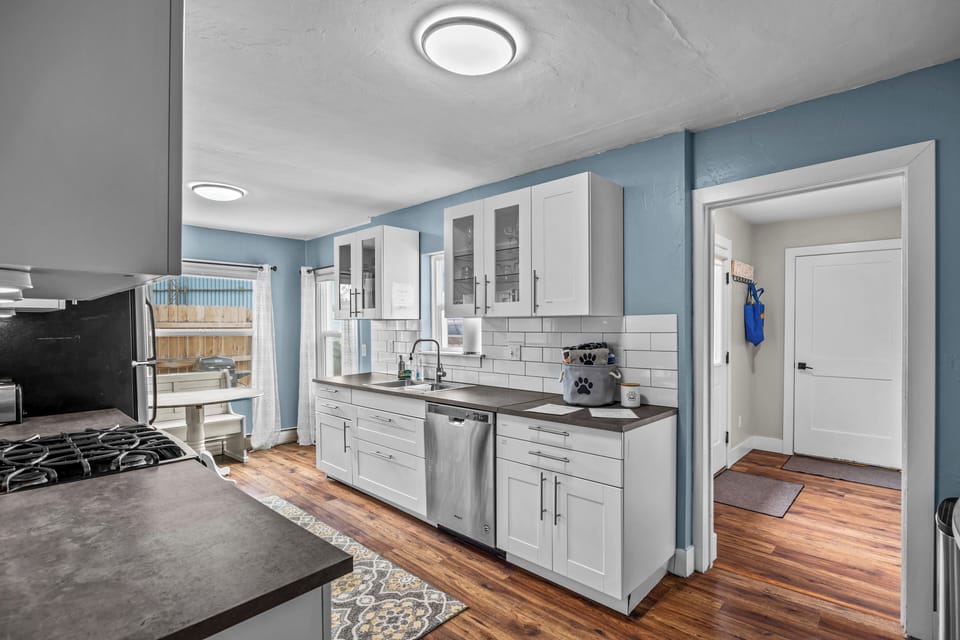 Kitchen & dining area with view to entryway and private attached garage.