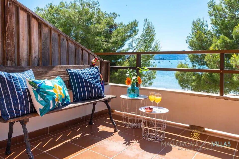 Chill-out terrace with bench, colorful cushions and sea views in Puerto de Pollensa, Mallorca, perfect for relaxing.