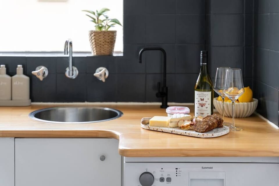 Kitchen with dishwasher, fridge, freezer, coffee pod machine, kettle, toaster, microwave and all your cookware and utensils provided for a mast-chef's night in.

