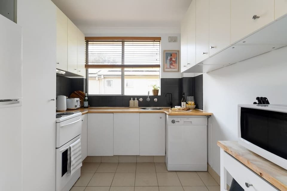 Kitchen with dishwasher, fridge, freezer, coffee pod machine, kettle, toaster, microwave and all your cookware and utensils provided for a mast-chef's night in.