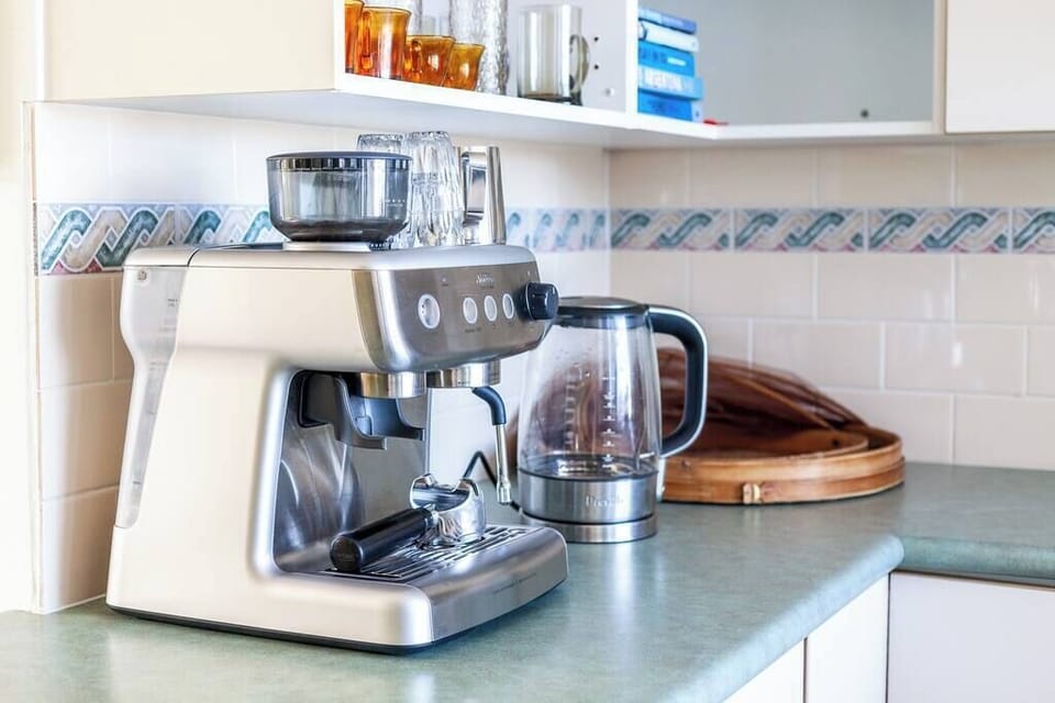 The full open plan kitchen opens onto the living areas inside and  bi fold window with stunning ocean views, large deck with relaxed seating and dining table. Enjoy a morning coffee from your own Espresso machine overlooking the ocean. 