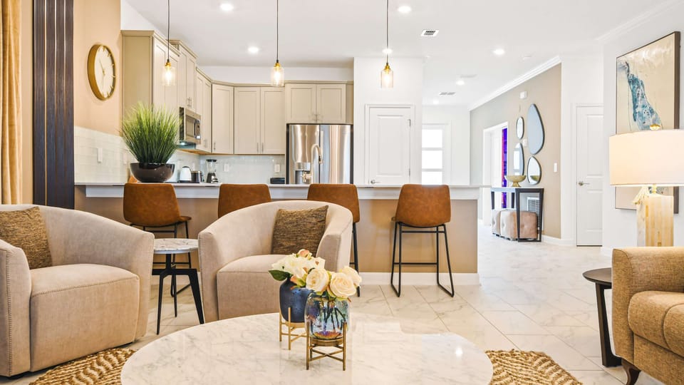 Stylish open-concept living space with a modern kitchen, cozy seating, and decor.